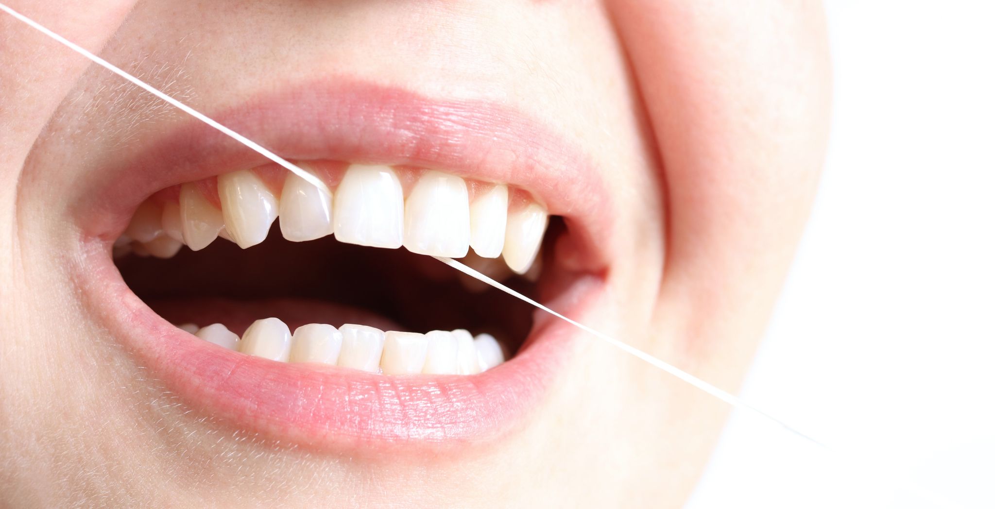 Benefits of flossing, thread passing between teeth